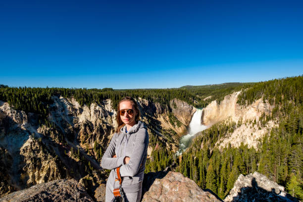 istock Tourist overlooking waterfall in Yellowstone 957234434