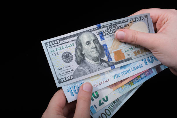 istock Hand holding American dollar  isolated on black background 957235226