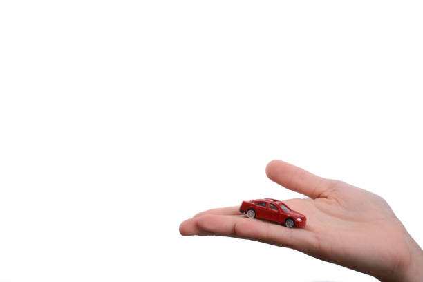 istock Child hand holding a red car 957235468