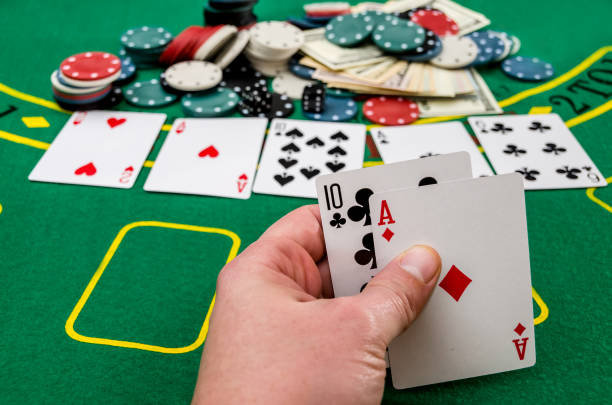 istock Man's hand showing card combination, gambling . 957238624