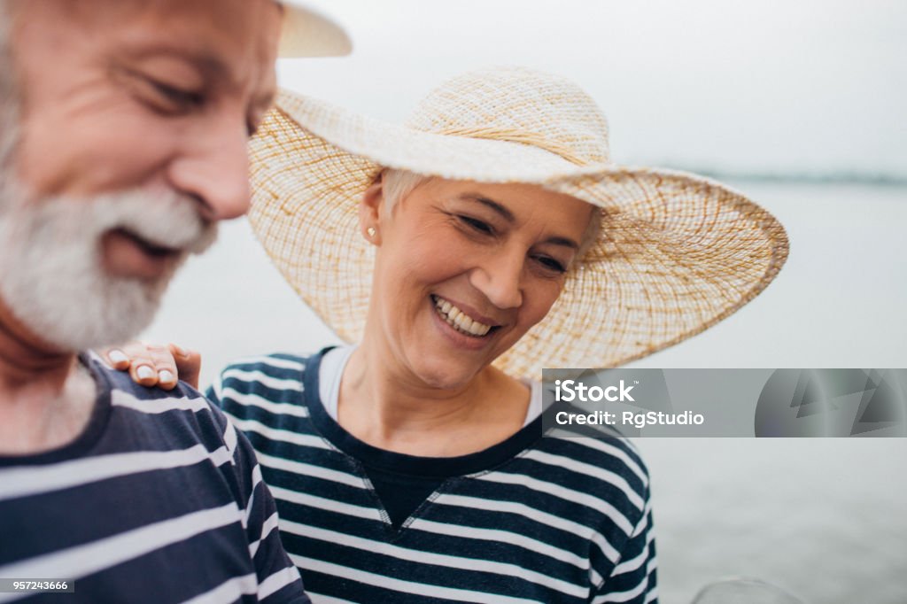 Happy mature couple with summer hats Senior couple in love enjoying outdoors Adult Stock Photo