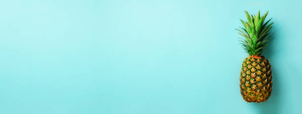 istock Pineapple on blue background. Top View. Copy Space. Pattern for minimal style. Pop art design, creative concept. Banner 957245022