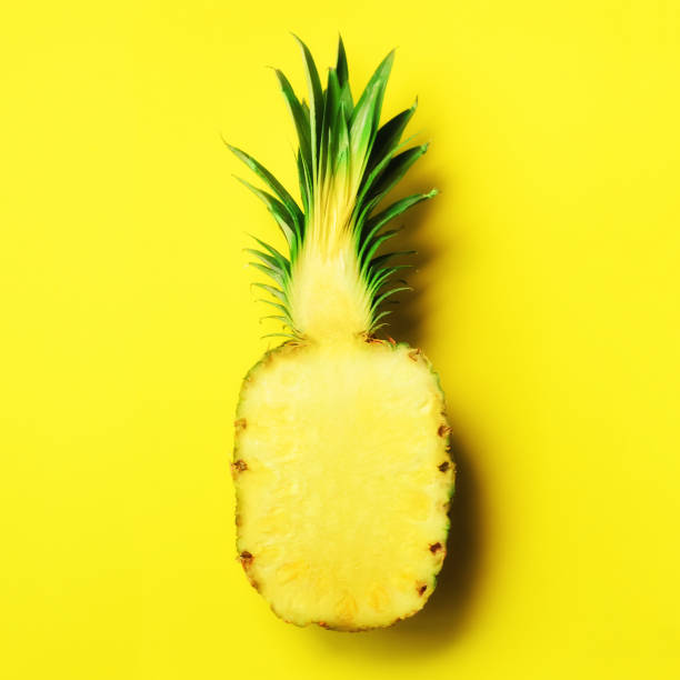 istock Half of sliced pineapple on yellow background. Top View. Copy Space. Bright pattern for minimal style. Square crop. Pop art design, creative concept 957248510