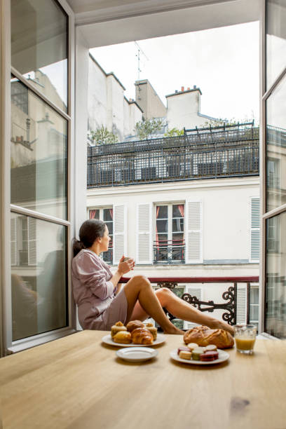 Woman having breakfast in hotel in Paris