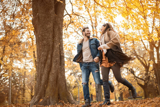 istock Below view of happy couple having fun while running. 957262912