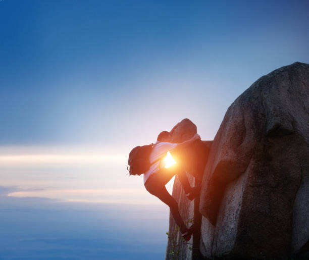istock A man reaching the top of a mountain 957277874