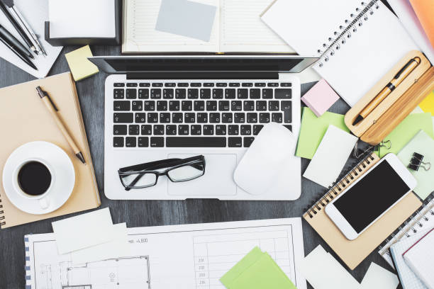 istock Contemporary wooden desk top with items 957280180