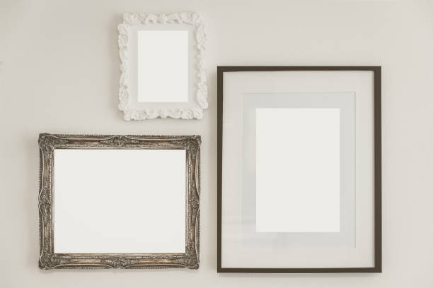 istock Vintage empty wooden frame on white concrete wall 957283122