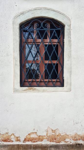 istock Wooden window frame and curved steel adjacent 957290088