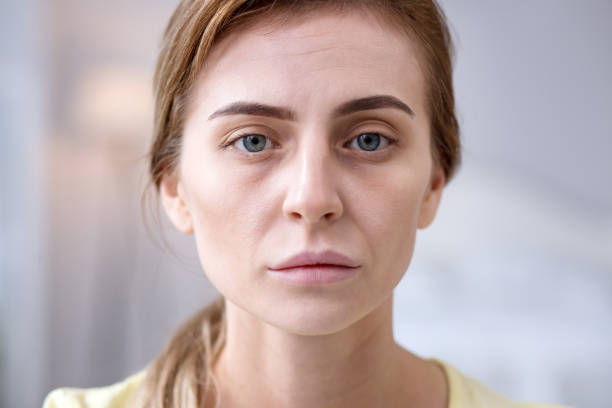 istock Cheerless sad woman looking at you 957290112