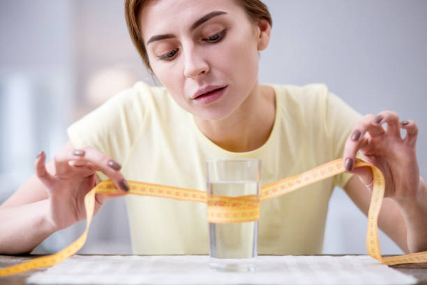 istock Nice serious woman holing a centimeter tape 957293014