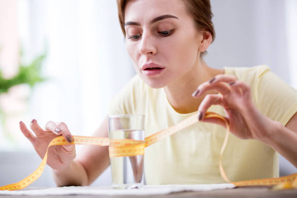 istock Nice young woman measuring the glass 957293152