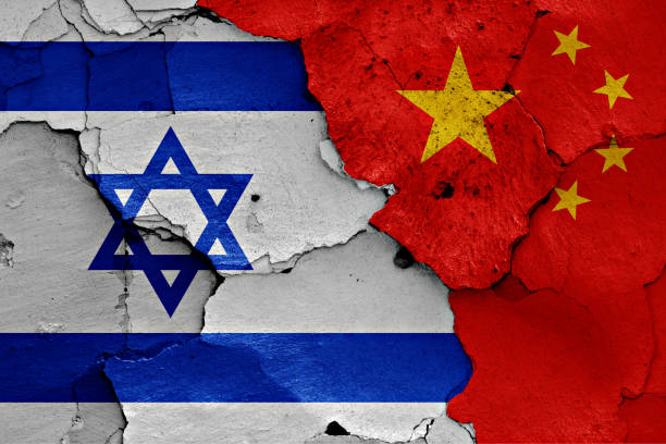 istock flags of Israel and China painted on cracked wall 957293564