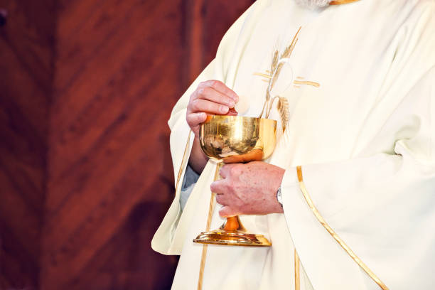 istock Communion and clergyman 957298844