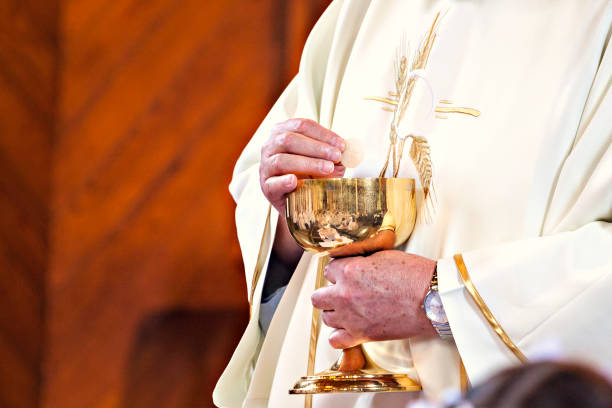 istock Communion and clergyman 957298858