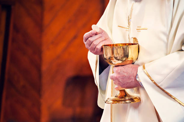 istock Communion and clergyman 957298910
