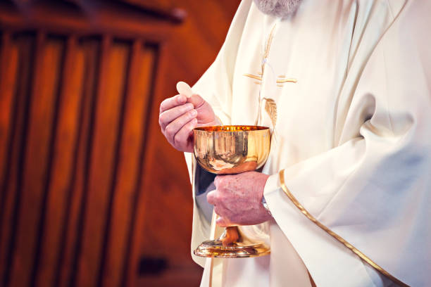 istock Communion and clergyman 957298932