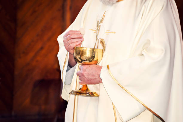 istock Communion and clergyman 957299010