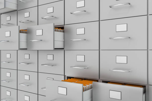 istock Filing cabinet with yellow folders in an open drawers 957299628