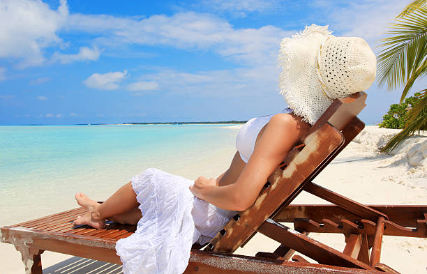 istock Woman resting on deck chair at the tropical beach. 95730287