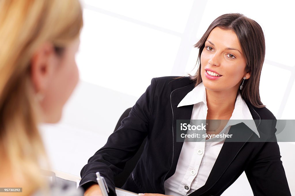 Businesswoman conducting job interview in brightly office  Adult Stock Photo