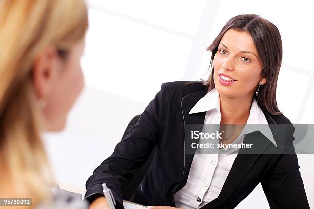 Businesswoman Conducting Job Interview In Brightly Office Stock Photo - Download Image Now