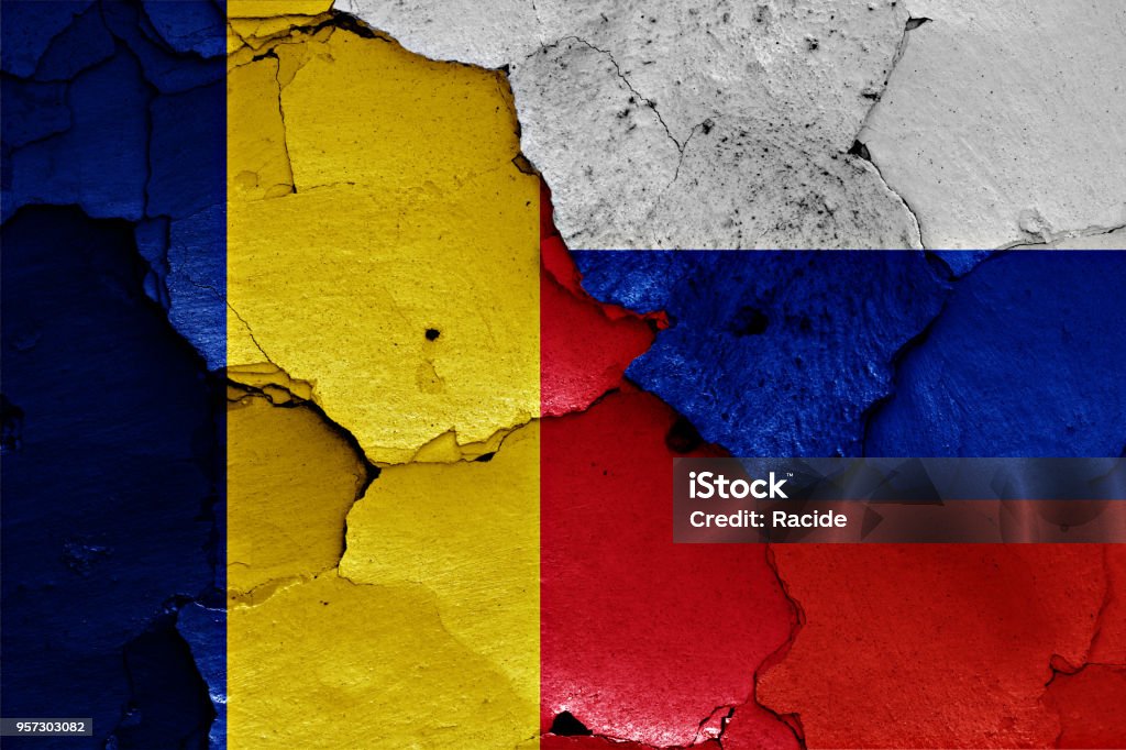 flags of Romania and Russia painted on cracked wall Romanian Flag Stock Photo