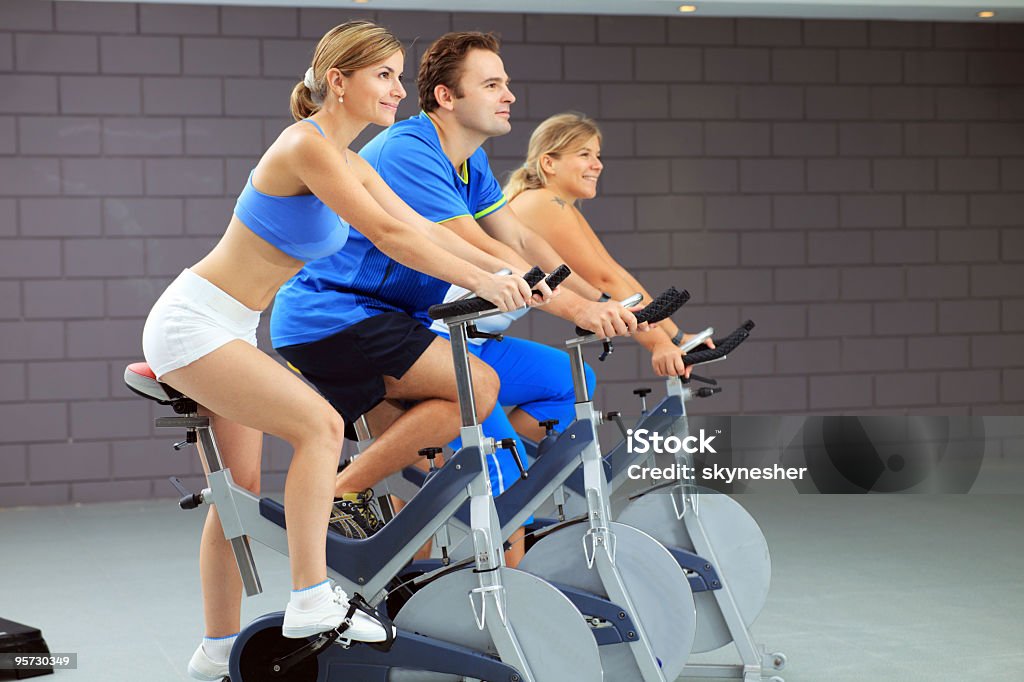 Young people training on exercise bike at the gym  Activity Stock Photo