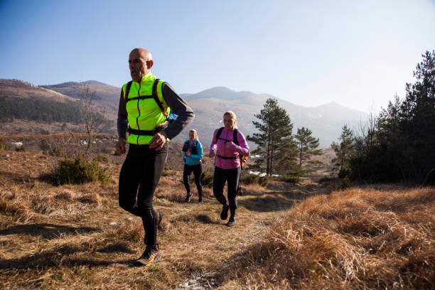 istock Man and women running 957305654