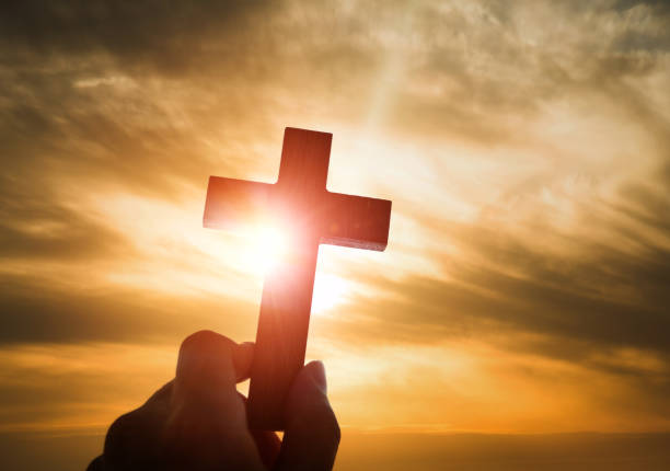istock Human hand holding wooden cross 957311194