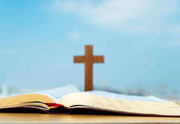 istock Bible and cross under the blue sky 957311270