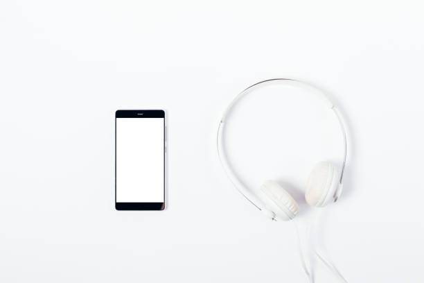 istock Mobile phone with blank screen and headphones 957312234