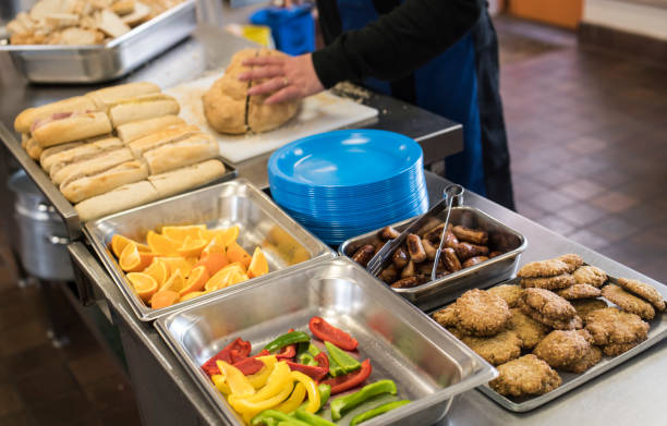 istock food being prepared in a school kitchen including sausages and bread 957315766
