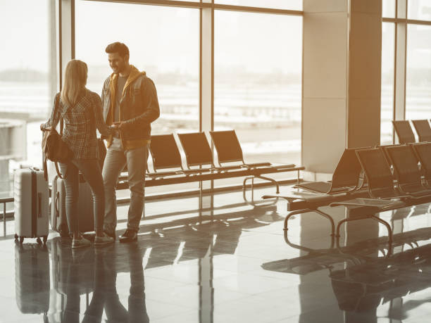 istock Outgoing man telling with female fedore flight 957316054
