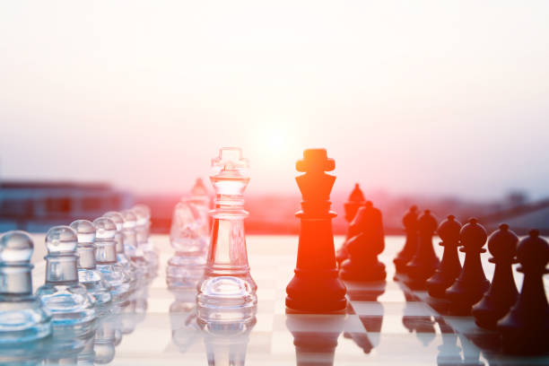 istock Transparent and black chess pieces on the board 957319804