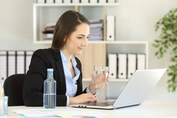 istock Office worker working holding a water glass 957319846
