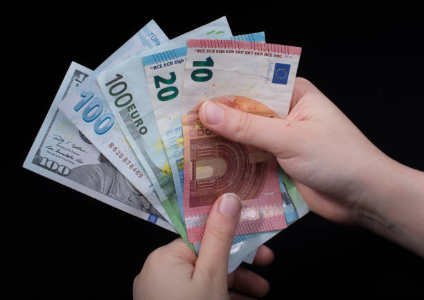 istock Hand holding American dollar  isolated on black background 957322592