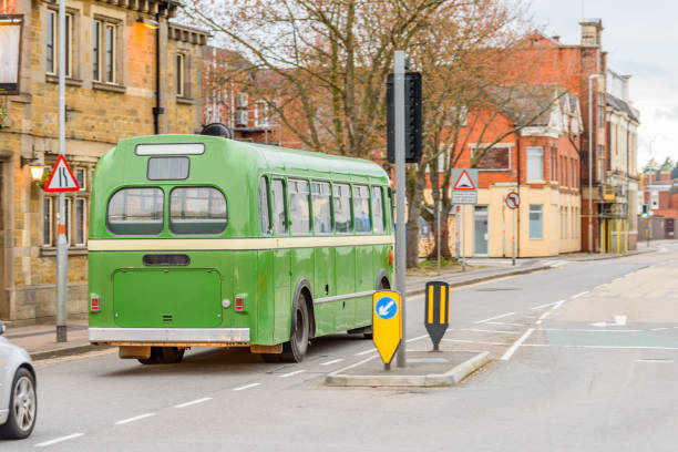 istock Green retro bus on British road in England 957323524