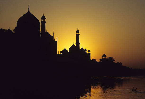 Skyline silhouette of Taj Mahal, Agra, India at the sunset The Taj Mahal was built on the orders of the Mughal Emperor Shah Jahan as a monument and mausoleum for his wife Mumtaz Mahal. Built between 1631 and 1654 by a workforce of more than twenty thousand, the Taj is an example of  Mughal architecture combining traditional elements of Indian and Persian design. persian empire stock pictures, royalty-free photos & images