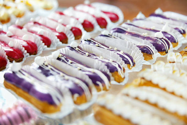 Pastry. Close Up Of Sweet Eclaires Lying In Shop Window. High Resolution.