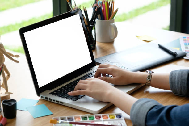 istock Mockup laptop computer using by creative graphic design woman with cropped shot. 957327998