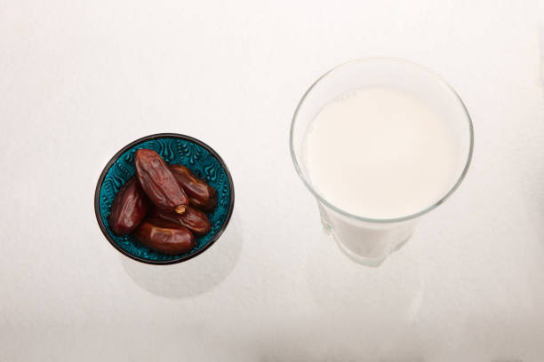 istock Dried dates and milk on white background 957329440