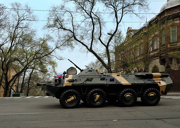 A Russian Armored Personnel Carrier or APC driving down an urban street in Vladivostok. Not much else here.