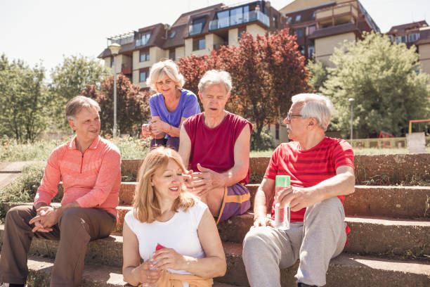 istock Group of senior friends resting after jogging 957331646