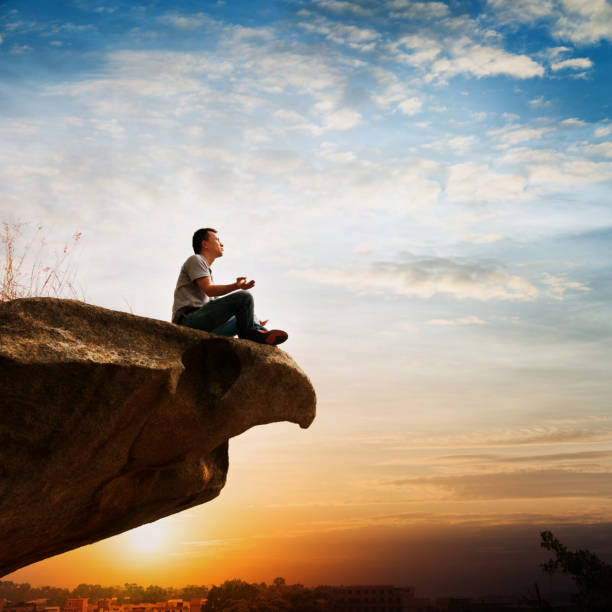 istock Meditation at the edge of a cliff 957332504