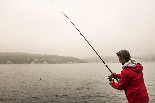 Fisherman, morning, serious, red coat