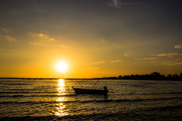 istock Silhouette Boat In Sea Against Sky During Sunset 957340928
