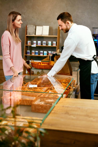 istock Pastry. Woman Choosing Fresh Bakery In Shop. 957341204