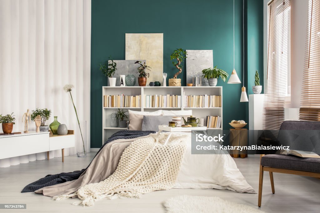 Beige blanket on white bed Bright and spacious bedroom interior with a wooden breakfast tray and a beige blanket on white bed with pillows Apartment Stock Photo