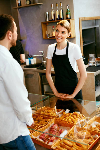 istock Bakery. Woman Working, Selling Bakery To Male 957344124